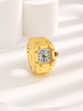 Vintage gold ring watch with square face featuring bold numerals, set against a minimalist background.