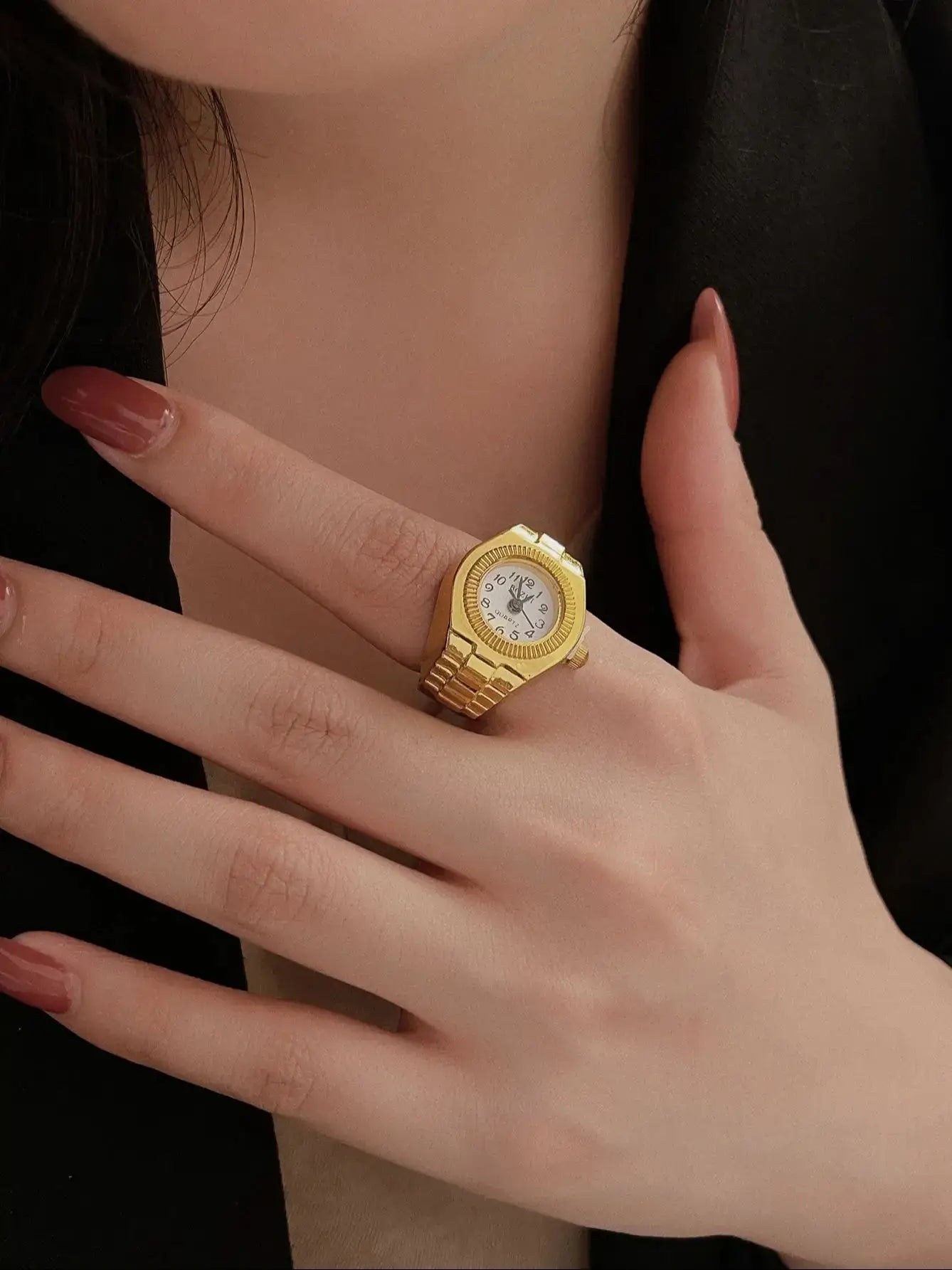 Gold vintage ring watch on a woman's hand, showcasing unique jewelry design.