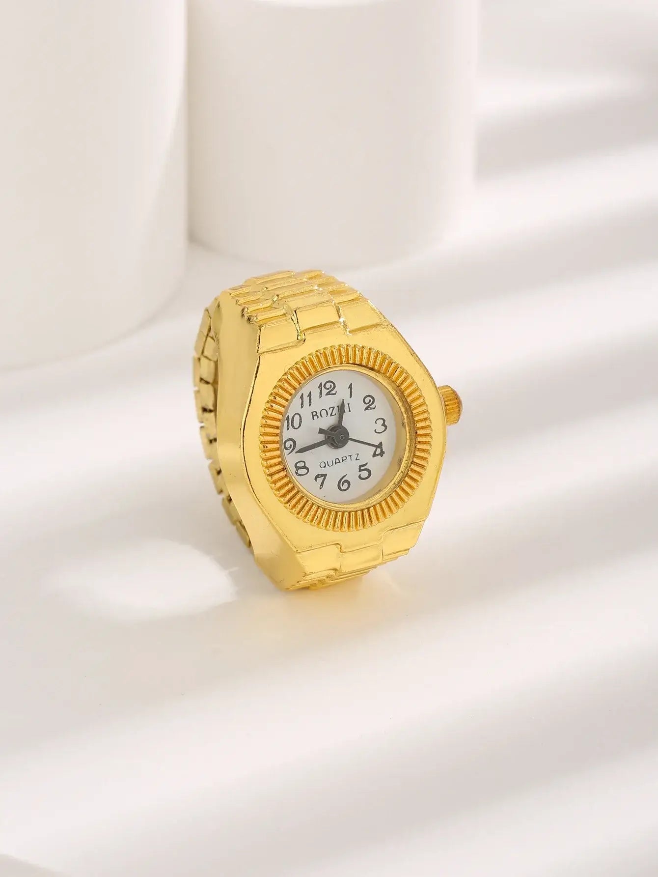 Gold vintage ring watch with classic design on white background.