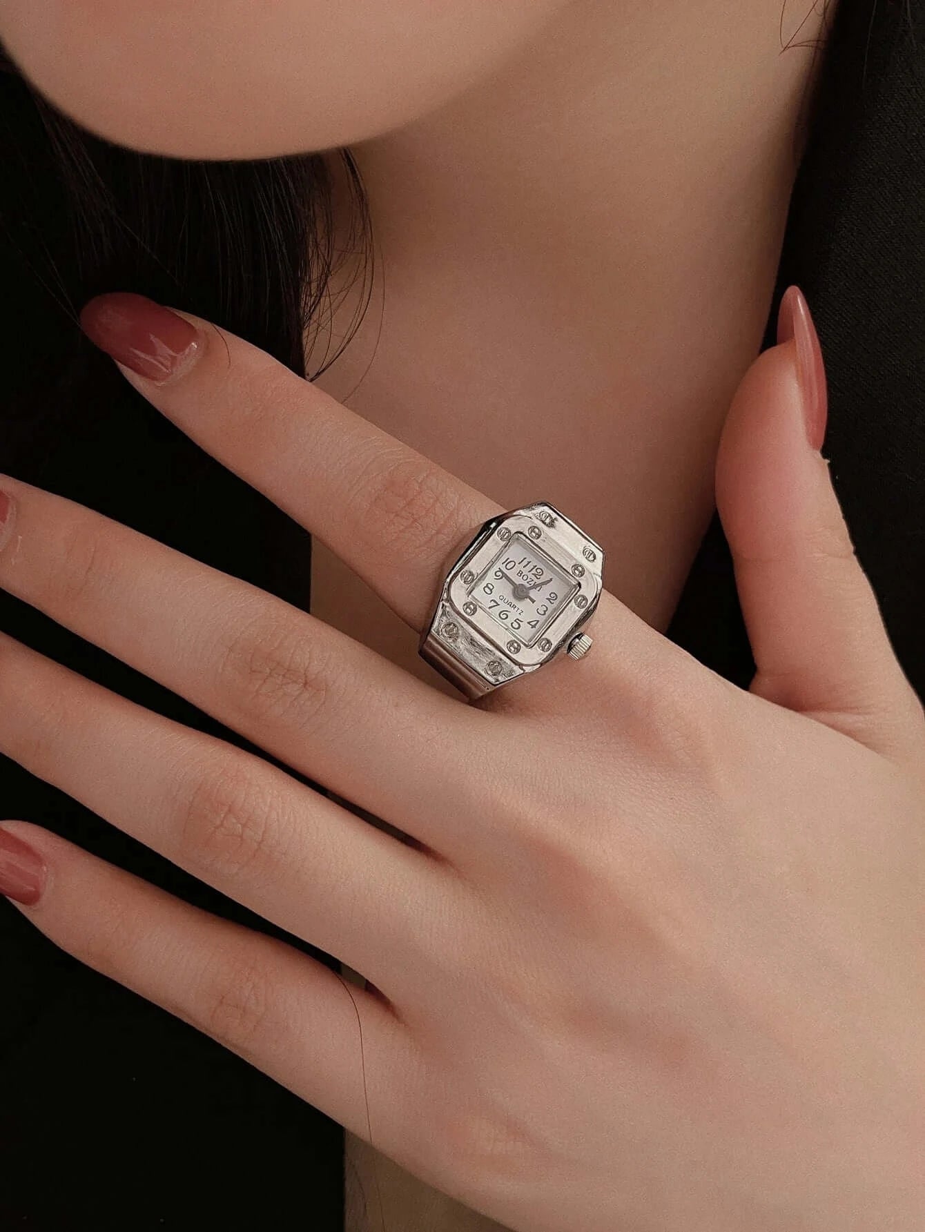 Elegant vintage ring watch displayed on a woman's hand, showcasing intricate design and timeless style.